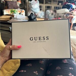 Brand new!! Never used!! Absolutely beautiful white with gold guess sneakers.